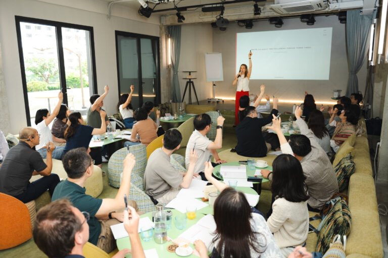 Training participants raising their hands participating