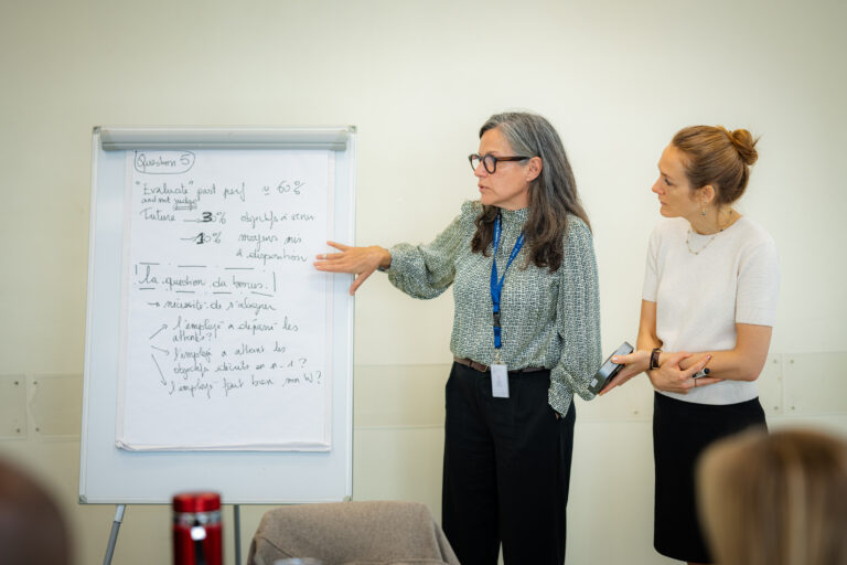 Participant running their whiteboard reflections to their teams.