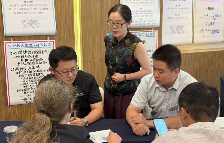 Participants working through a real cross-cultural negotiation case study