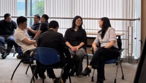 Team members during a coaching session, working through a communication exercise together.