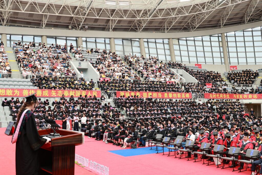 Viktória delivering a graduation speech at a Fudan University graduation ceremony in Shanghai